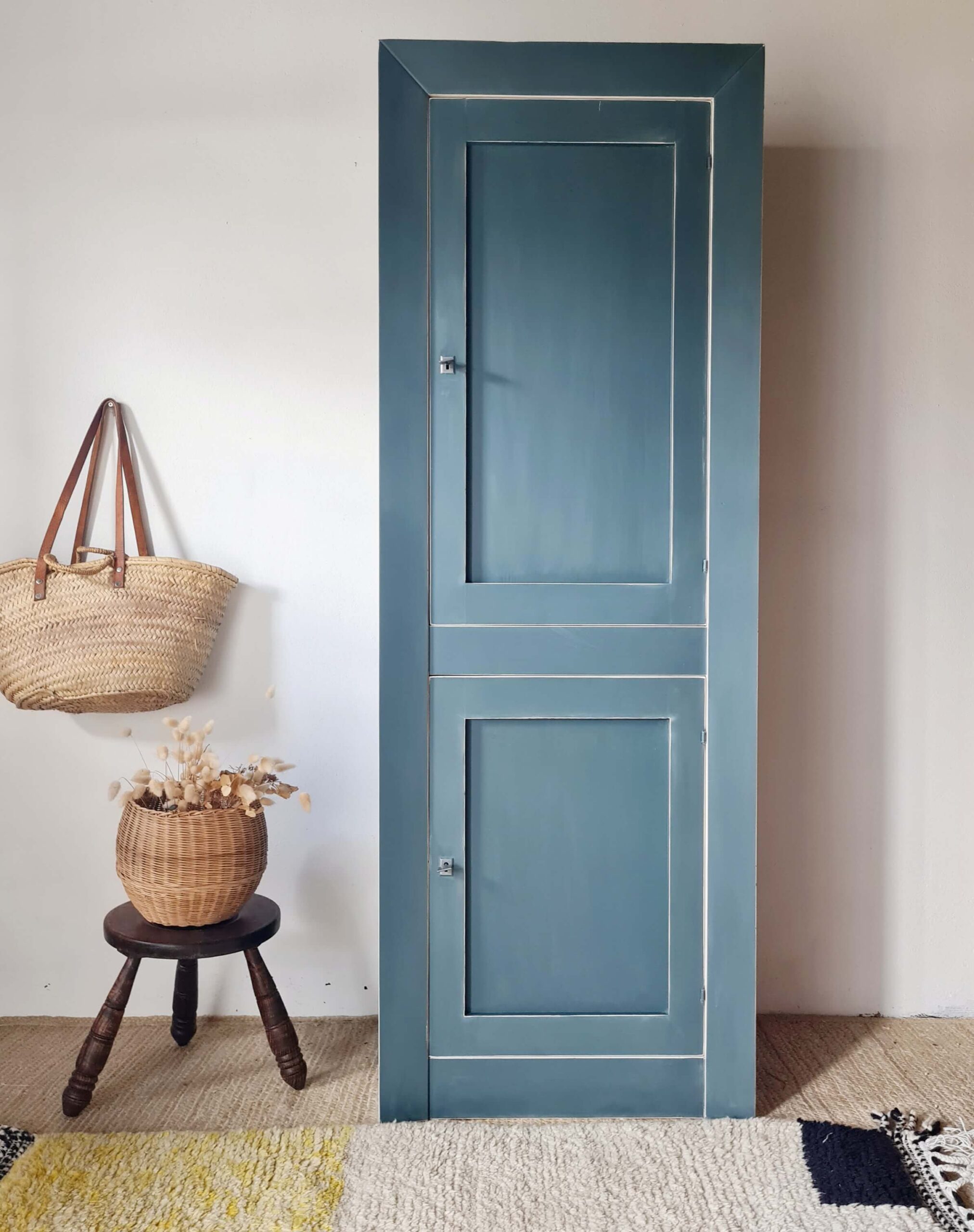 Vue complète d'une armoire haute en bois massif peinte en bleu, idéale pour une décoration d'intérieur au style campagne chic.