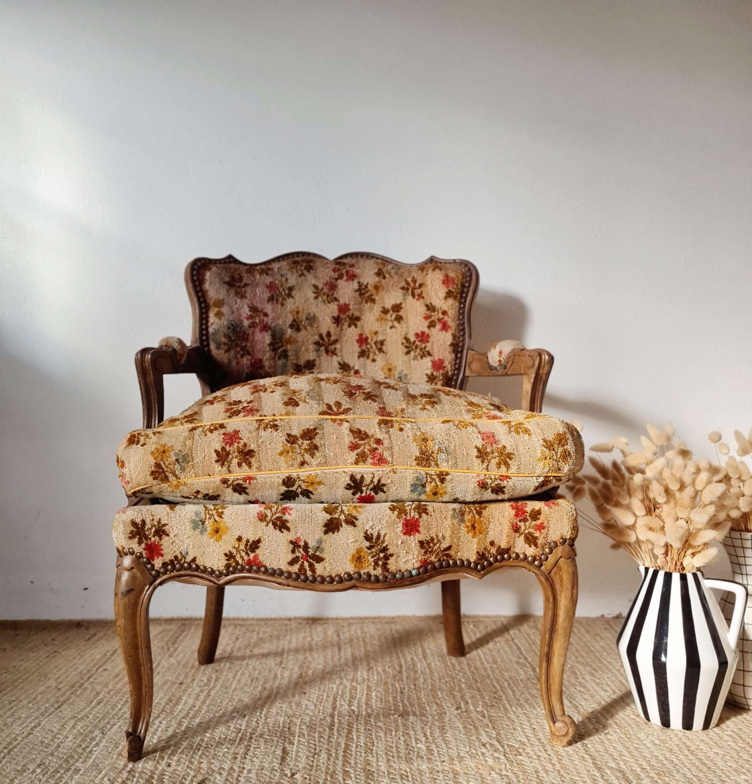 Elégance d'un fauteuil ancien sur piétement galbé en bois et motifs fleuris